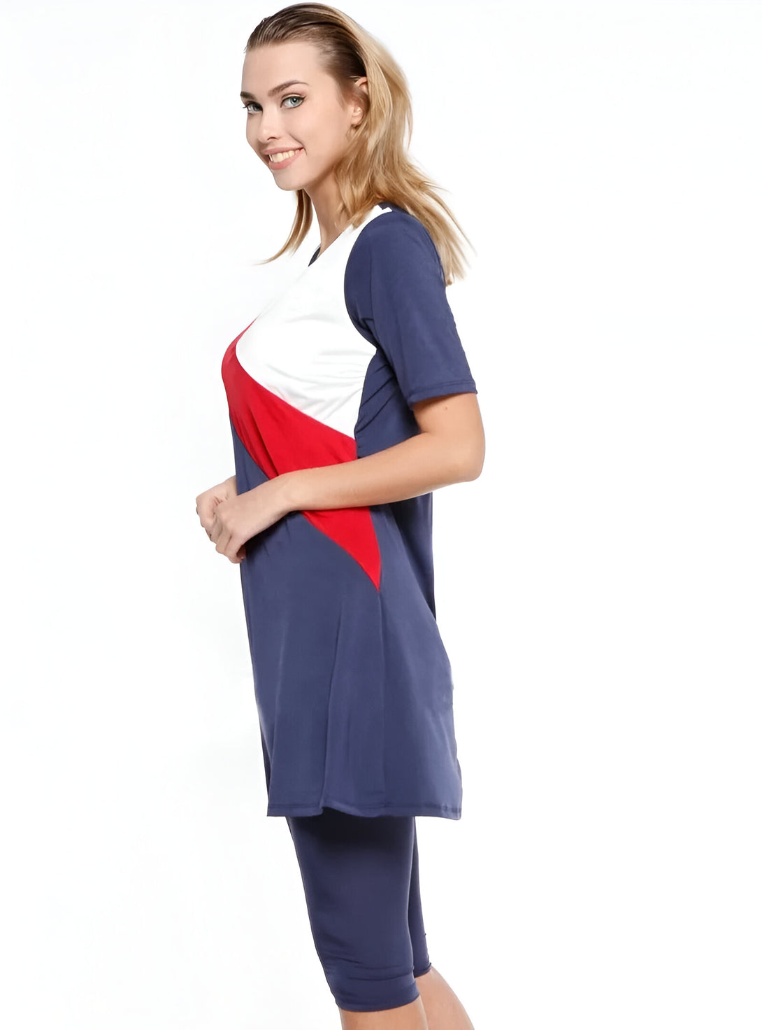 Une femme portant un maillot de bain musulman bleu marine, blanc et rouge avec des leggings assortis.
