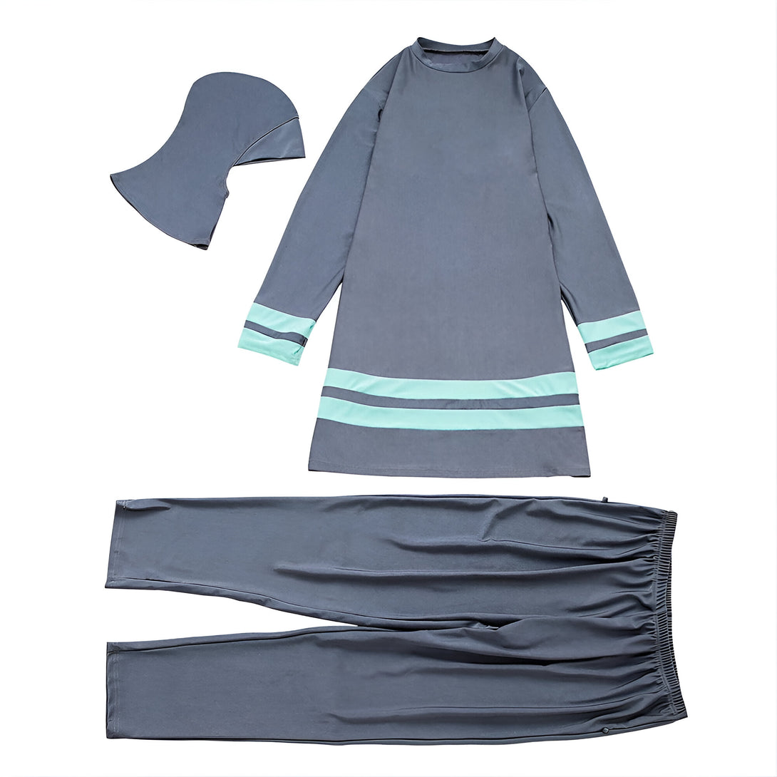 Ensemble de vêtements musulmans pour femmes, comprenant un hijab, une tunique à manches longues avec des bandes turquoise et un pantalon gris.