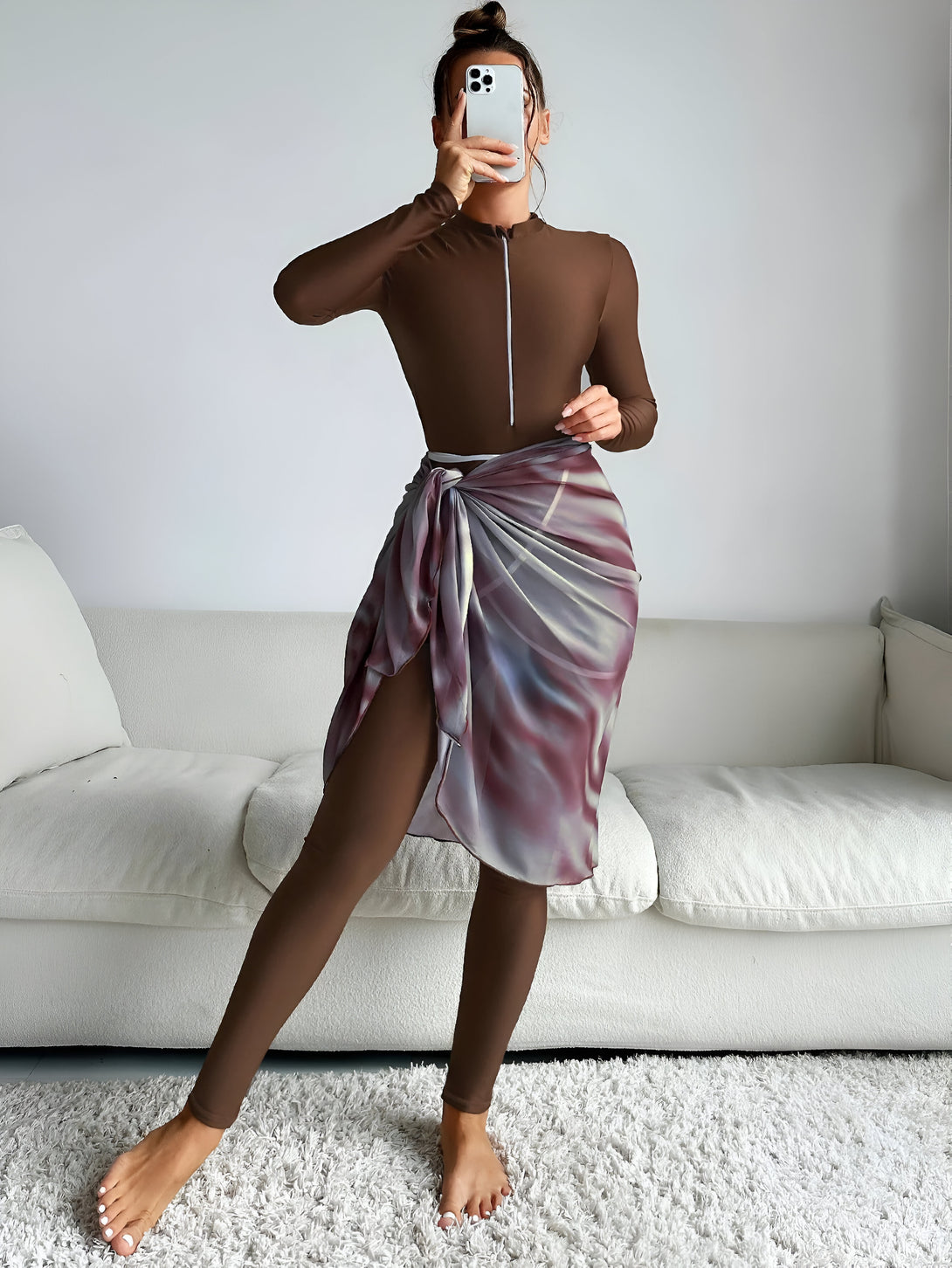 Une femme portant un ensemble de vêtements musulmans marron avec une jupe nouée à l' imprimé tie-dye.