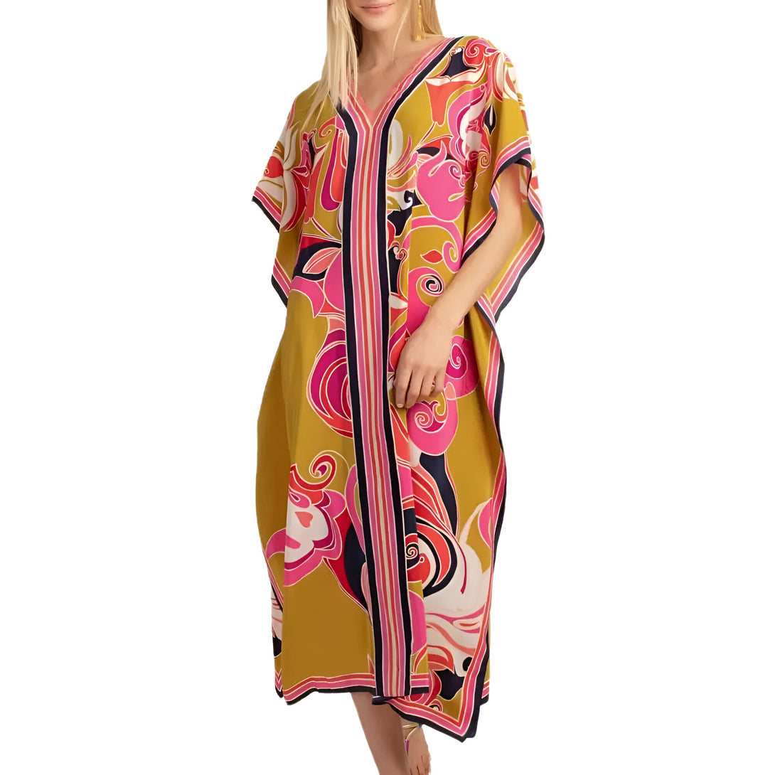 Une robe longue musulmane avec un imprimé floral coloré, idéale pour les occasions spéciales. La robe est jaune moutarde avec des motifs bleus, roses et blancs.