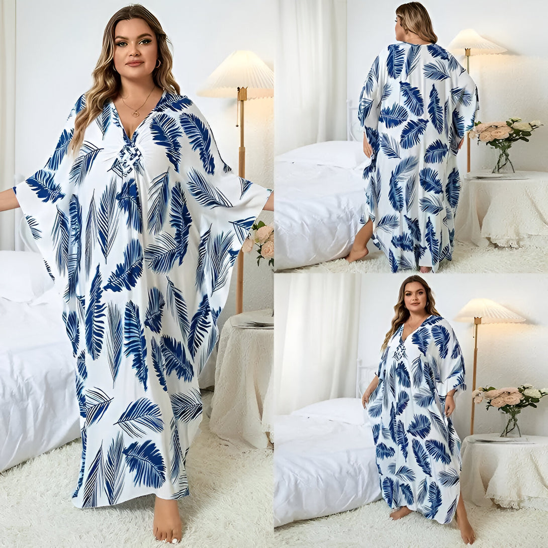 Robe longue à manches longues pour femmes avec un imprimé de feuilles bleues sur fond blanc. Parfaite pour les occasions spéciales ou pour un look décontracté chic.