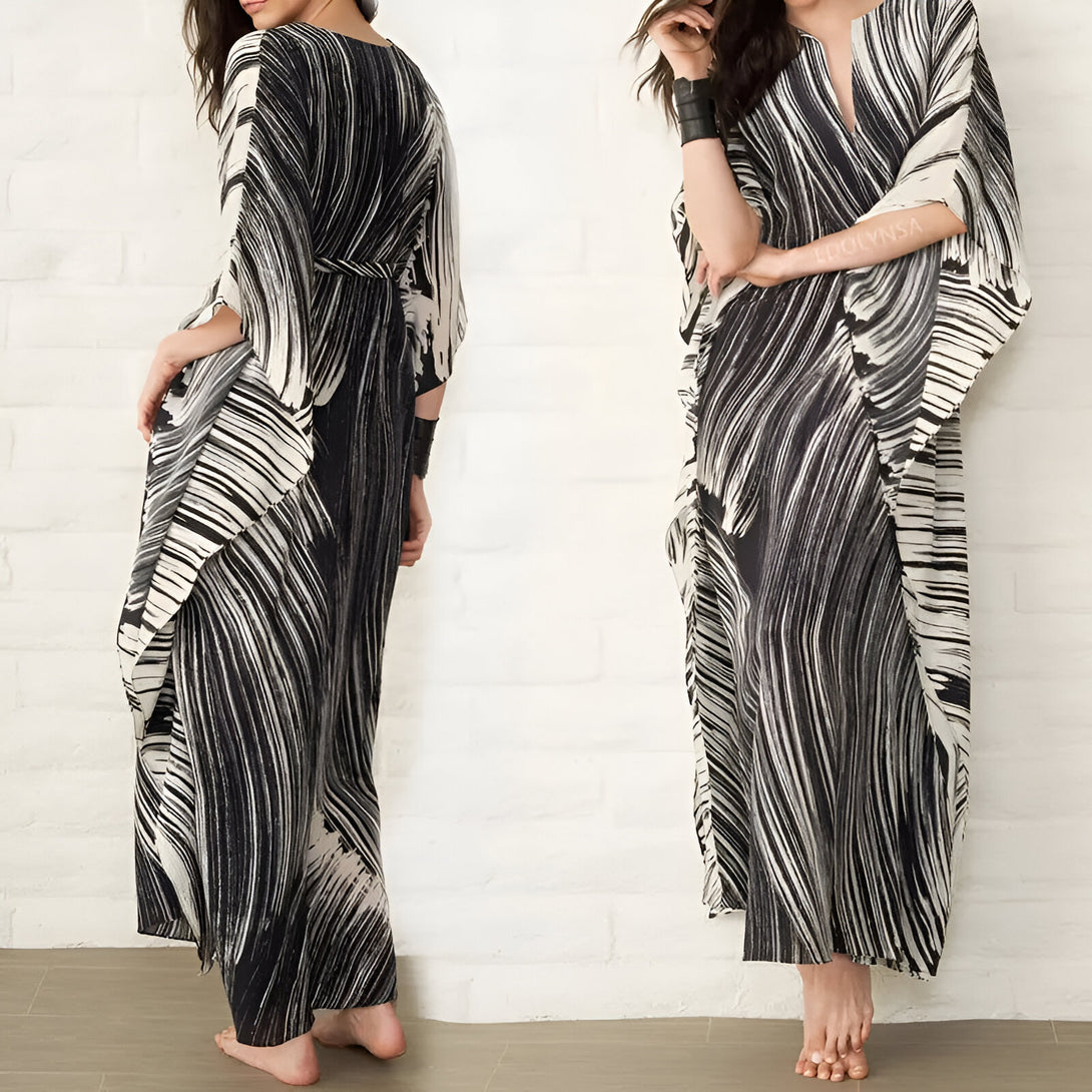 Robe longue musulmane à manches longues, avec un imprimé noir et blanc en forme de vagues, idéale pour les occasions spéciales. La robe est ample et confortable, avec une coupe qui flatte la silhouette.