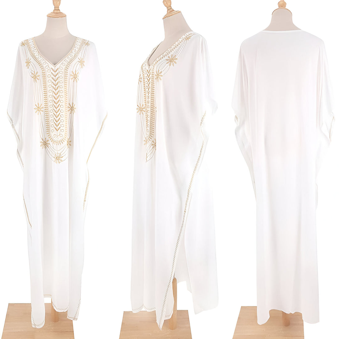 Robe blanche ample avec broderies dorées, idéale pour les occasions spéciales ou pour un look décontracté chic.