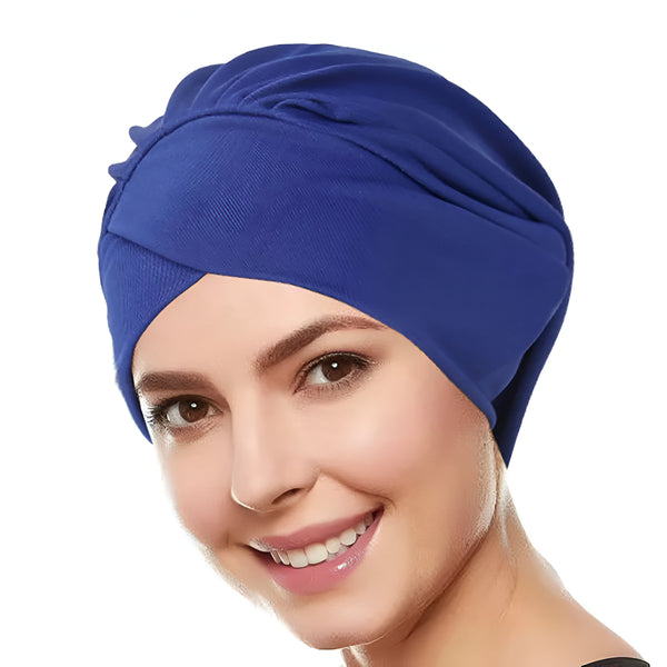 Une femme souriante portant un hijab bleu.
