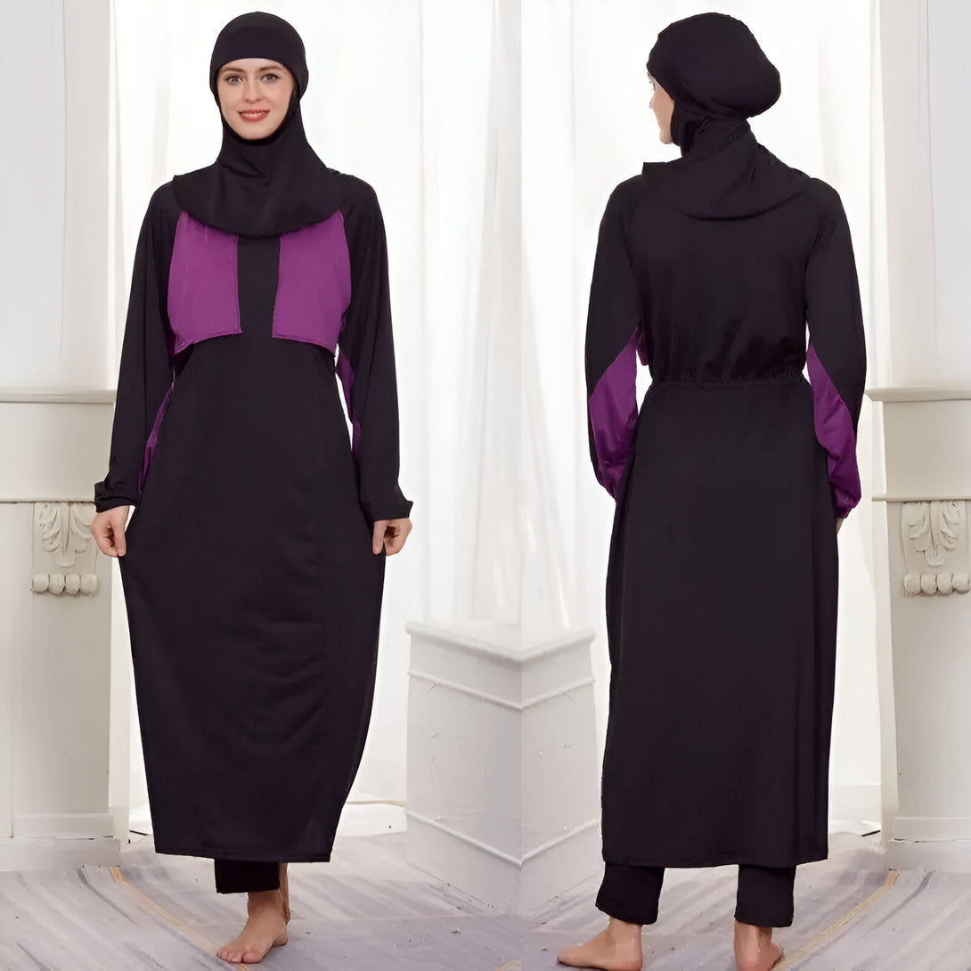 Une femme porte un maillot de bain musulman noir avec des accents violets. Le maillot de bain a des manches longues et une jupe longue.